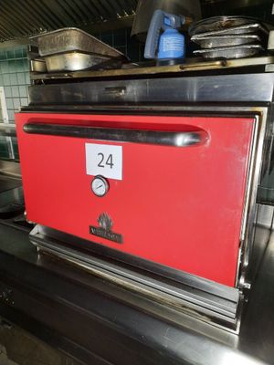 un four rouge posé sur un plan de travail dans une cuisine