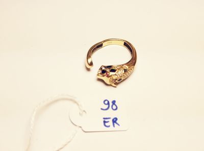 a gold ring with a cat ' s head on it next to a price tag