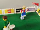 two legos that are playing a game of soccer