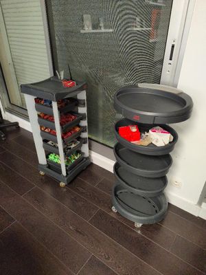 a black cart with food in it in front of a window