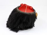an image of a black and red hat with a wooden handle