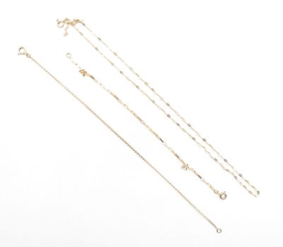 a set of four gold chain necklaces