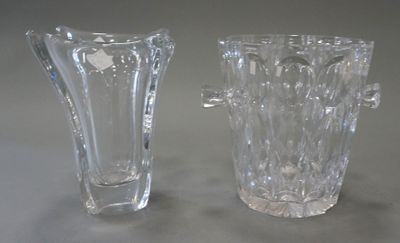 two glass vases sitting next to each other on a table
