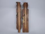 two wooden sculptures of two people standing next to each other
