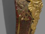 an ornate gold and red vase on a gray surface