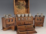 three wooden drawers with jars on them and a painting on the wall