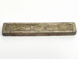 a close up of a metal object on a white surface