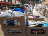 several boxes of clothing are stacked on top of each other in a warehouse