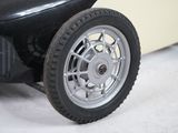 a close up of a toy car with a wheel on it