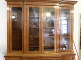 an image of a wooden china cabinet with glass doors