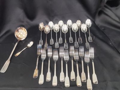a lot of silver spoons and forks on a table