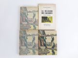 three books sitting on top of each other on a white surface