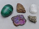 some rocks and stones are sitting on a table next to each other