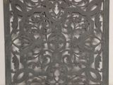 a close up of a decorative metal panel on a wall