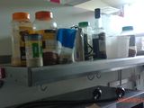 a shelf that has spices and other items on it