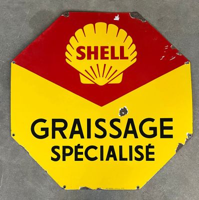 a red and yellow stop sign with a shell logo on it