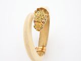an image of a ring with a leopard head on it ' s side