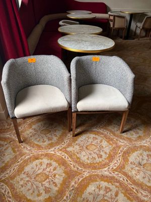 two chairs and a table in the corner of a room