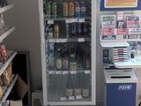 a vending machine in a grocery store with a lot of food