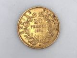 a close up of a gold coin on a white surface