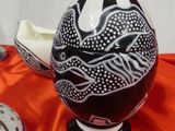 a black and white vase on a red table cloth