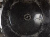 a black bowl sitting on top of a wooden table