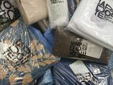 a large pile of clothing that is in a store