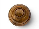 a brown glass object on a white surface