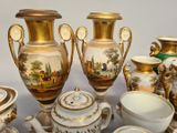 many vases and bowls that are sitting on a table