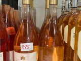 several bottles of wine are lined up on a shelf