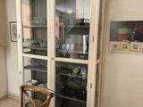 a table and chairs in a room with a cabinet