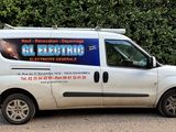 a white van that is parked in front of a hedge