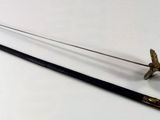 a sword and a stick sitting on a table