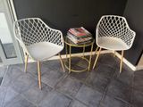 two chairs sitting next to each other on a tiled floor