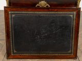 a black and gold frame with a clock on top of it
