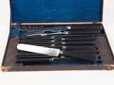 six knives in a case on a white surface
