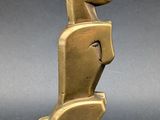 an image of a gold sculpture of a dog on a stand