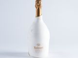 white bottle of champagne with a gold cap on a white background