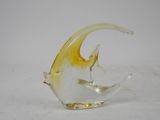 a glass sculpture of a fish on a white surface