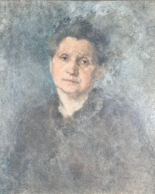 portrait of a woman in a black dress by a blue background