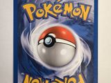 a close up of a pokemon card on a white surface