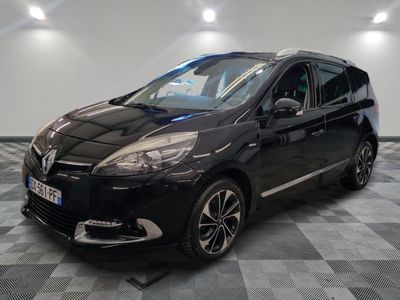 the black car is parked on a checkered floor in the garage