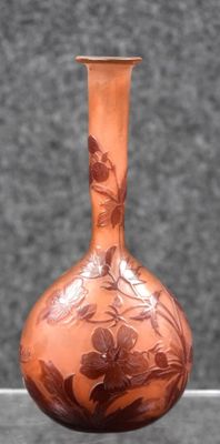 a brown vase with a floral design on it
