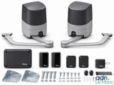 two black and silver speakers are sitting next to each other on a white surface