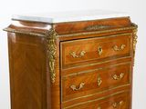 a wooden chest of drawers with a marble top