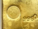 an image of a gold bar with a coin on top of it