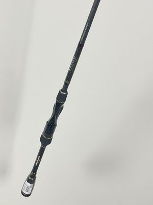a close up of a fishing rod on a white surface