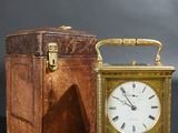 an image of a small clock sitting next to a wooden box