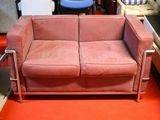 a pink couch sitting on a red carpet in a room