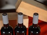 four bottles of wine are lined up in a row on a table